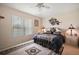 Bedroom featuring a queen bed, plush carpeting, a large window, and coordinated decor at 8043 Pine Hollow Dr, Mount Dora, FL 32757