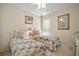 Bright bedroom features two beds, a ceiling fan, and decor at 8043 Pine Hollow Dr, Mount Dora, FL 32757