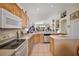 Bright kitchen featuring ample counter space, light wood cabinetry, tile flooring, and modern appliances at 8043 Pine Hollow Dr, Mount Dora, FL 32757