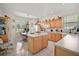 Cozy kitchen with an island and warm wood cabinets, bathed in natural light at 8043 Pine Hollow Dr, Mount Dora, FL 32757