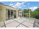 This screened patio features tiled floors, white framing, and views of a green backyard at 8043 Pine Hollow Dr, Mount Dora, FL 32757