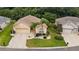 Single-story house with a two-car garage and palm trees at 16984 Se 109Th Ave, Summerfield, FL 34491