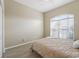 Bedroom with a queen bed and a window with blinds at 16984 Se 109Th Ave, Summerfield, FL 34491