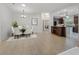 Bright dining room with chandelier and view into kitchen at 16984 Se 109Th Ave, Summerfield, FL 34491