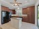 Bright kitchen boasts granite countertops, dark cabinetry, and an island at 16984 Se 109Th Ave, Summerfield, FL 34491