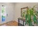 Welcoming foyer with a white front door, tile flooring, and a decorative mirror at 9342 Oglethorpe Dr, Groveland, FL 34736