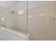 Bright shower features tiled walls, glass enclosure, and modern fixtures in neutral tones at 9342 Oglethorpe Dr, Groveland, FL 34736