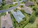 An aerial view showcasing a single-Gathering home's roofline, landscaping, and driveway at 486 Troy Loop, The Villages, FL 32162