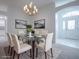 Bright dining room featuring a glass table and six white chairs at 486 Troy Loop, The Villages, FL 32162