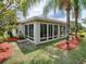 House exterior with a large sunroom addition at 486 Troy Loop, The Villages, FL 32162