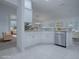 Modern white kitchen with stainless steel appliances and breakfast bar at 486 Troy Loop, The Villages, FL 32162