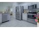 Stainless steel appliances and white cabinetry in this kitchen at 486 Troy Loop, The Villages, FL 32162