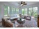 Bright sunroom with wicker furniture and tile flooring at 486 Troy Loop, The Villages, FL 32162