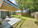 Spacious backyard with a pergola, firepit, and ample green space at 14598 Sw 34Th Terrace Rd, Ocala, FL 34473