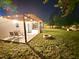 Night time view of the backyard with lights, fire pit, seating and plenty of grass at 14598 Sw 34Th Terrace Rd, Ocala, FL 34473