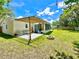 Outdoor living space featuring a charming patio, pergola, modern seating, and a cozy fire pit in a large backyard at 14598 Sw 34Th Terrace Rd, Ocala, FL 34473