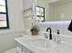Updated bathroom featuring a marble vanity and stylish geometric wallpaper at 14598 Sw 34Th Terrace Rd, Ocala, FL 34473