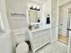 Stylish bathroom featuring patterned tile floors, shiplap, and a vanity with a marble countertop at 14598 Sw 34Th Terrace Rd, Ocala, FL 34473