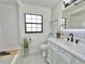 Stylish bathroom with patterned tile floors, a modern vanity, and updated fixtures at 14598 Sw 34Th Terrace Rd, Ocala, FL 34473