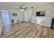 Bright bedroom with stylish accent wall, ceiling fan, and wood-look floors with ensuite bathroom at 14598 Sw 34Th Terrace Rd, Ocala, FL 34473