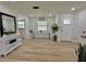 Bright entryway featuring shiplap walls, wood-look flooring, and a built-in bench with a unique live edge table at 14598 Sw 34Th Terrace Rd, Ocala, FL 34473