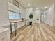 Bright entryway features shiplap walls, wood-look floors, and a unique live edge table with hairpin legs at 14598 Sw 34Th Terrace Rd, Ocala, FL 34473