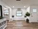 Inviting entryway with shiplap walls, built-in bench seating, and a view into the adjacent kitchen at 14598 Sw 34Th Terrace Rd, Ocala, FL 34473