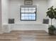 Bright entryway with a built-in bench, window, and wood-look floors at 14598 Sw 34Th Terrace Rd, Ocala, FL 34473