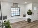 Inviting foyer with bench seating by a large window, wood-look floors, and stylish decor at 14598 Sw 34Th Terrace Rd, Ocala, FL 34473