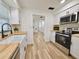 Bright kitchen features butcher block counters, stainless appliances, and a view into the living areas at 14598 Sw 34Th Terrace Rd, Ocala, FL 34473