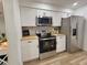 Updated kitchen with stainless steel appliances, white cabinets, and wood countertops at 14598 Sw 34Th Terrace Rd, Ocala, FL 34473