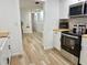 Bright kitchen featuring stainless steel appliances and light wood flooring at 14598 Sw 34Th Terrace Rd, Ocala, FL 34473