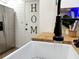 Close-up of kitchen sink with modern faucet, butcher block countertops and white cabinets at 14598 Sw 34Th Terrace Rd, Ocala, FL 34473