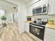 Modern kitchen with stainless steel appliances, butcher block countertops and white cabinetry at 14598 Sw 34Th Terrace Rd, Ocala, FL 34473