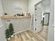 Functional laundry area with brick-look accent wall, wood shelf, and updated flooring at 14598 Sw 34Th Terrace Rd, Ocala, FL 34473