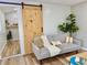 Cozy living room with a stylish sliding barn door, comfortable seating, and modern decor at 14598 Sw 34Th Terrace Rd, Ocala, FL 34473