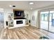 Bright living room with a modern fireplace, built-in shelves, and sliding glass doors at 14598 Sw 34Th Terrace Rd, Ocala, FL 34473