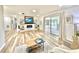 Spacious living room with built-in shelving, fireplace, and sliding glass doors to an enclosed patio at 14598 Sw 34Th Terrace Rd, Ocala, FL 34473