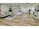 Open-concept living room with light wood floors, shiplap accent wall, and neutral decor at 14598 Sw 34Th Terrace Rd, Ocala, FL 34473