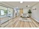 Bright living room with wood-look floors, large windows, sliding glass doors, and a sliding barn door at 14598 Sw 34Th Terrace Rd, Ocala, FL 34473