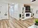 Open-concept living room featuring a modern fireplace and built-in shelves at 14598 Sw 34Th Terrace Rd, Ocala, FL 34473