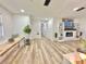 Open-concept living room with fireplace, built-in shelving, shiplap walls, and wood-look flooring at 14598 Sw 34Th Terrace Rd, Ocala, FL 34473
