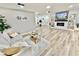 Open-concept living room with a fireplace, modern decor, and comfortable seating at 14598 Sw 34Th Terrace Rd, Ocala, FL 34473