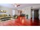 Bright living room features a ceiling fan, stylish furniture, and beautiful hardwood floors at 601 W Old Hwy 441 # 11B, Mount Dora, FL 32757