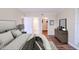 Calming main bedroom features plush bedding, a dresser, and an ensuite bathroom at 601 W Old Hwy 441 # 11B, Mount Dora, FL 32757