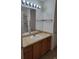 Bathroom features a large mirror, granite countertop, and walk-in shower at 9215 Se 177Th Simons Ln, The Villages, FL 32162