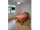 Bedroom featuring hardwood floors, a ceiling fan, and a window providing natural light at 9215 Se 177Th Simons Ln, The Villages, FL 32162