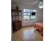 Bedroom with window view, wood laminate floor, and small cabinet at 9215 Se 177Th Simons Ln, The Villages, FL 32162