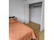 Bedroom with hardwood floors and closet at 9215 Se 177Th Simons Ln, The Villages, FL 32162
