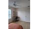 Bedroom featuring workspace, laminate floor, and ceiling fan at 9215 Se 177Th Simons Ln, The Villages, FL 32162